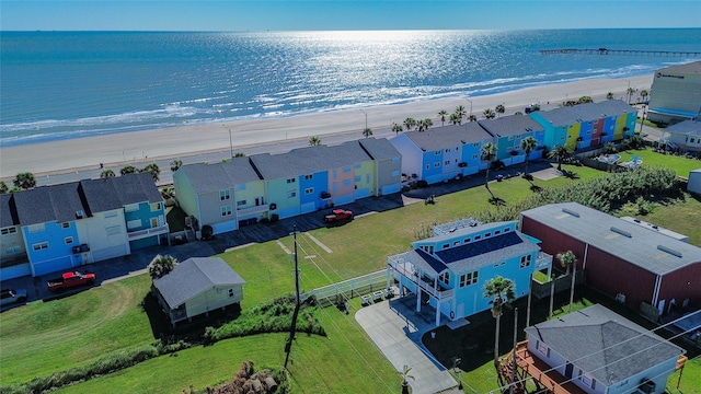 bird's eye view with a water view and a beach view