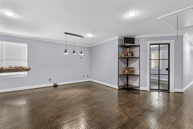 unfurnished room with dark wood-type flooring, a textured ceiling, and ornamental molding