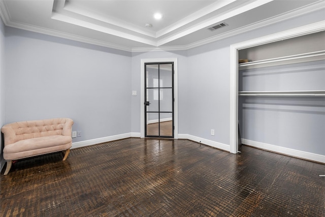 sitting room with crown molding and a tray ceiling