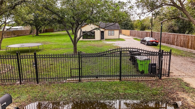 view of yard with a water view and a trampoline