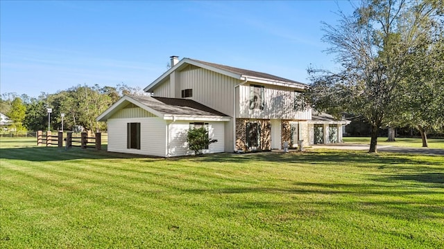 back of property featuring a yard