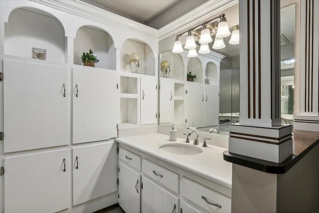 bathroom featuring crown molding and vanity