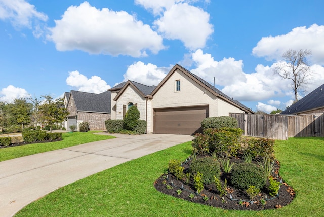 view of front of house featuring a garage and a front lawn