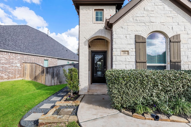 entrance to property featuring a yard