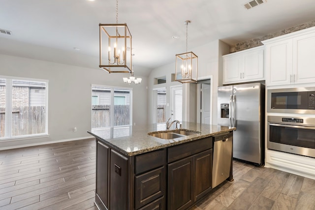 kitchen featuring hardwood / wood-style flooring, sink, stainless steel appliances, and a wealth of natural light