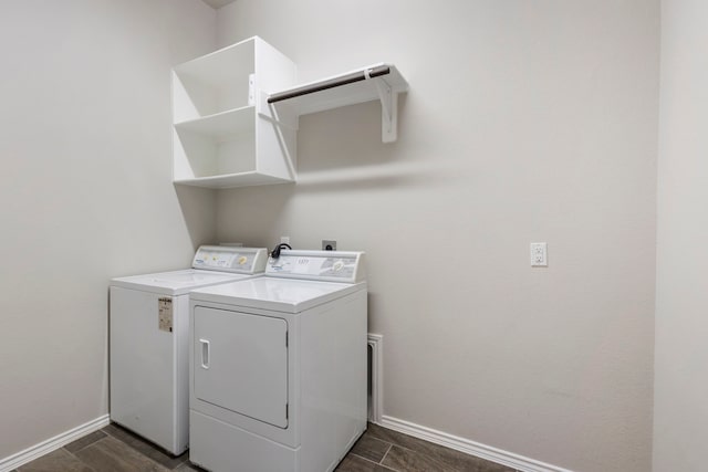 laundry room with independent washer and dryer and dark hardwood / wood-style flooring