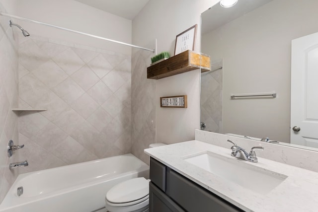 full bathroom with vanity, tiled shower / bath combo, and toilet