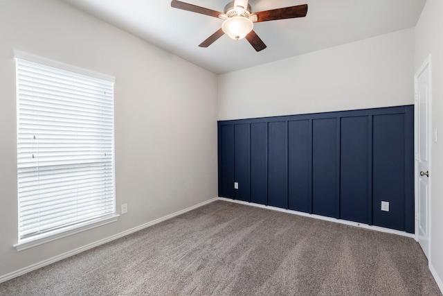 spare room with carpet floors and ceiling fan