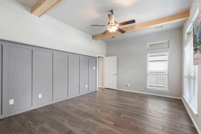 unfurnished bedroom with ceiling fan, dark hardwood / wood-style flooring, and beamed ceiling