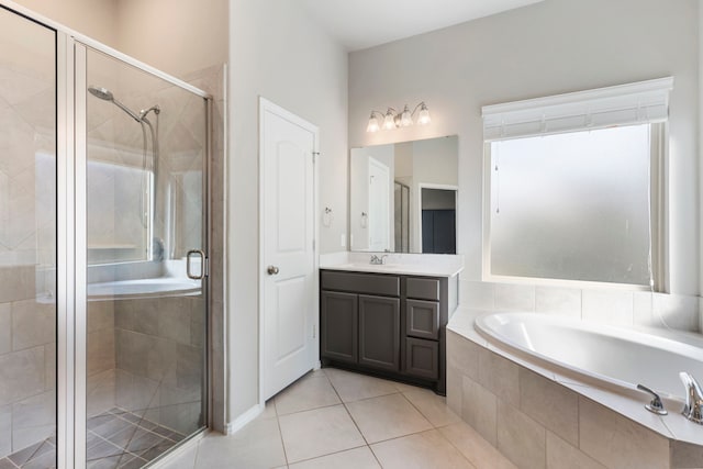 bathroom featuring tile patterned flooring, shower with separate bathtub, and vanity