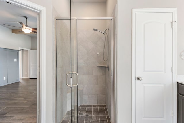 bathroom with ceiling fan, a shower with door, vanity, and wood-type flooring