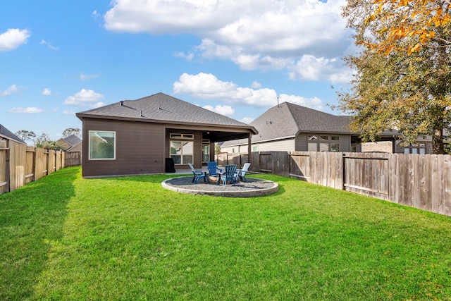 rear view of property featuring a yard and a patio