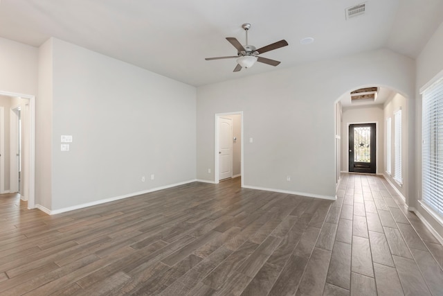 unfurnished living room featuring vaulted ceiling, ceiling fan, and dark hardwood / wood-style floors