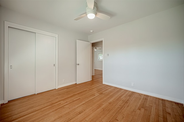 unfurnished bedroom with a closet, ceiling fan, and light wood-type flooring