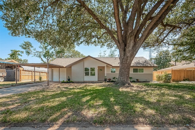 single story home with a front yard, a garage, and a carport