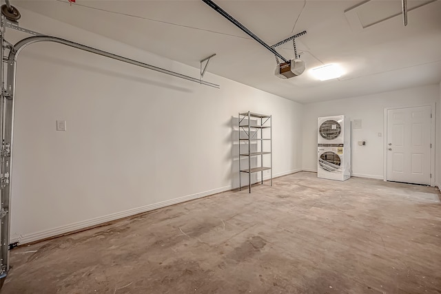 garage featuring a garage door opener and stacked washer and dryer