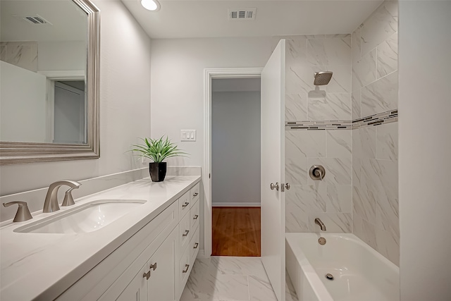 bathroom featuring vanity and tiled shower / bath combo