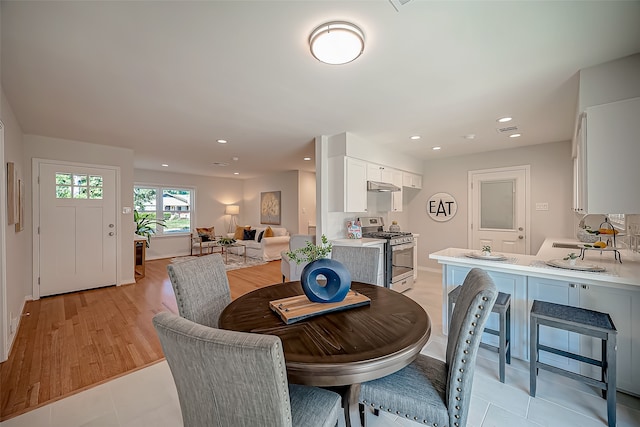 dining area with light hardwood / wood-style flooring and sink