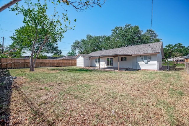 back of house featuring a yard and a patio