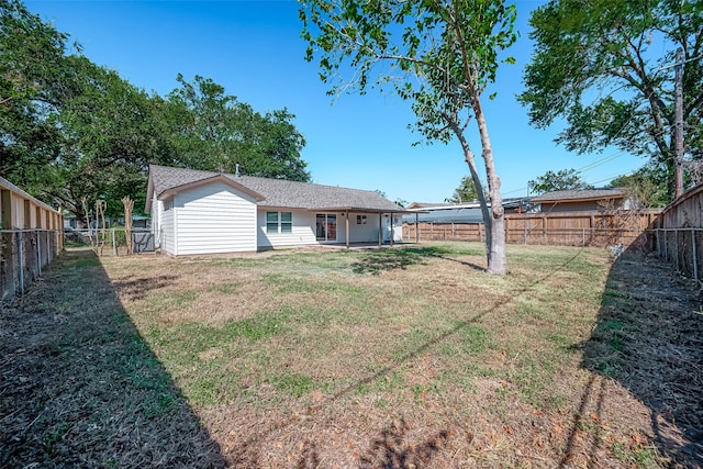 rear view of property with a lawn