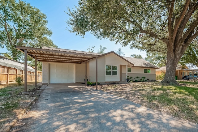 ranch-style house featuring a garage and a carport