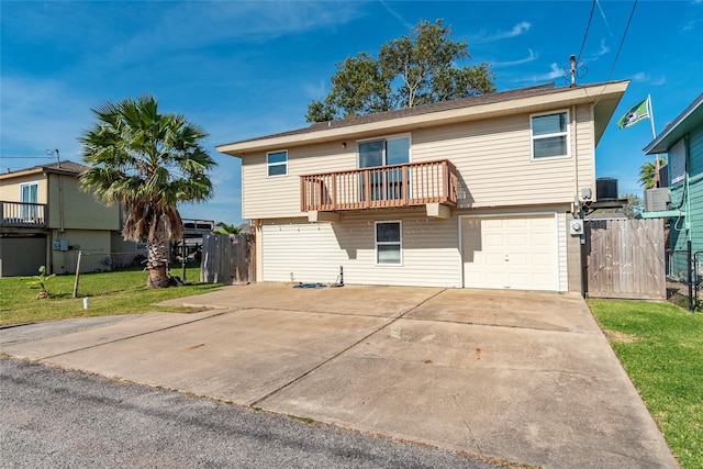 rear view of property featuring a yard, a balcony, and a garage