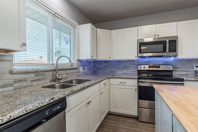 kitchen with white cabinetry, sink, and stainless steel appliances