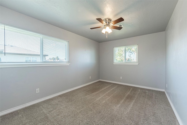 spare room with carpet flooring, a textured ceiling, and ceiling fan