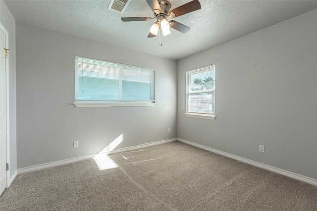 unfurnished room featuring carpet flooring, ceiling fan, and a textured ceiling