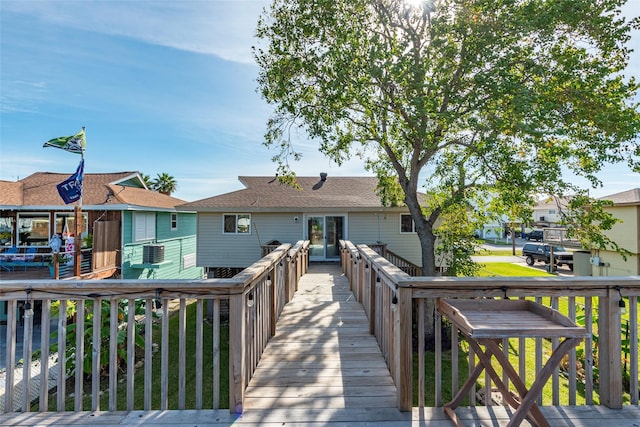 back of house featuring cooling unit and a wooden deck