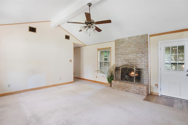 unfurnished living room featuring carpet flooring, vaulted ceiling with beams, ceiling fan, and a fireplace