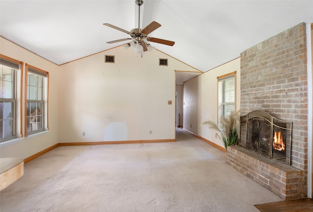 unfurnished living room with ceiling fan, carpet floors, high vaulted ceiling, and a brick fireplace