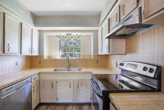 kitchen with crown molding, dark hardwood / wood-style flooring, sink, and stainless steel appliances