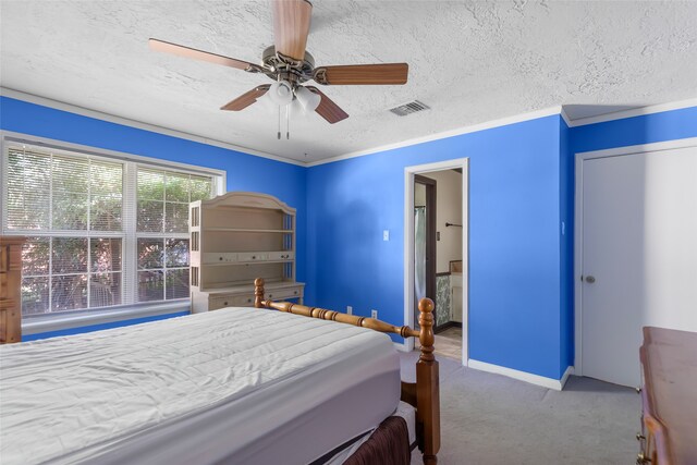 bedroom with ceiling fan, carpet floors, a textured ceiling, and ornamental molding