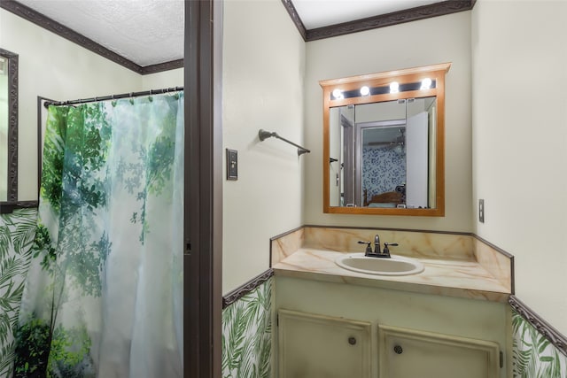 bathroom featuring a textured ceiling, vanity, curtained shower, and crown molding