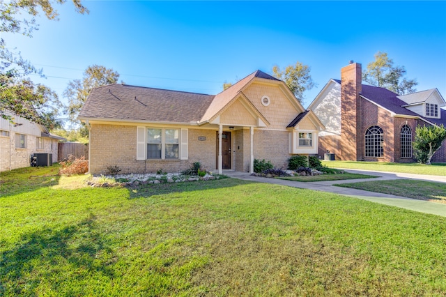 view of front of property with a front lawn and central air condition unit