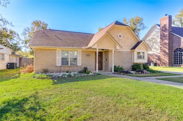 view of front of house with central AC unit and a front yard