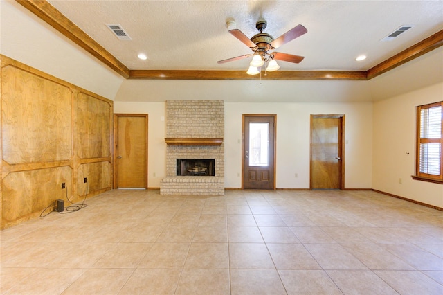 unfurnished living room featuring light tile patterned floors, a textured ceiling, plenty of natural light, and ceiling fan