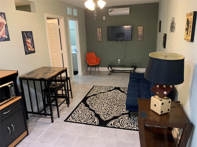 living room with ceiling fan, light tile patterned flooring, and a wall unit AC