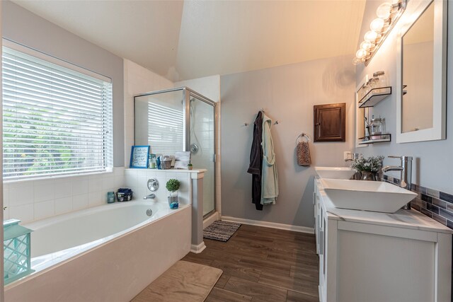 bathroom featuring hardwood / wood-style flooring, vanity, independent shower and bath, and vaulted ceiling