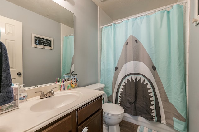 bathroom with a shower with shower curtain, hardwood / wood-style floors, vanity, and toilet