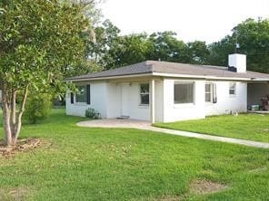 back of house with a yard