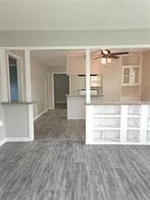 unfurnished living room with dark wood-type flooring