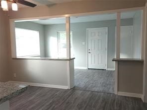 interior space featuring ceiling fan and dark hardwood / wood-style floors