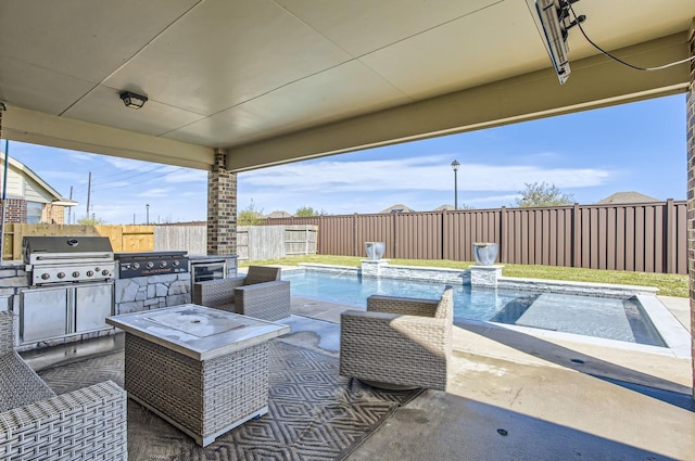 view of patio / terrace with an outdoor kitchen, a fenced in pool, pool water feature, and grilling area