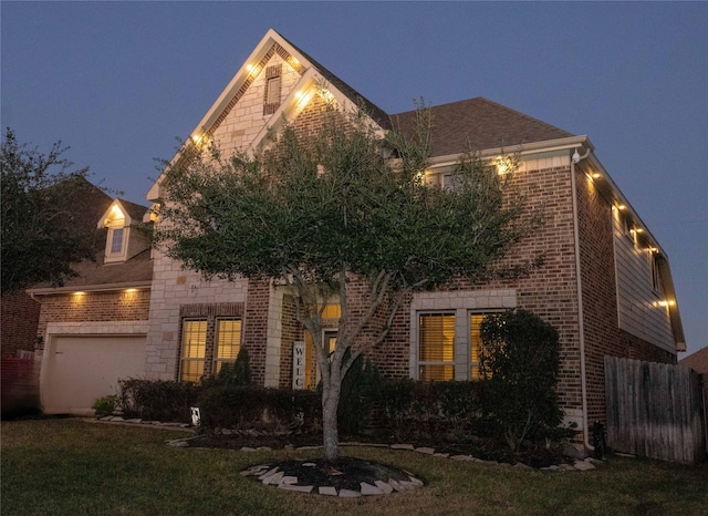 view of front of property with a garage and a front lawn