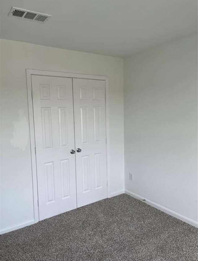 unfurnished bedroom featuring a closet and carpet floors