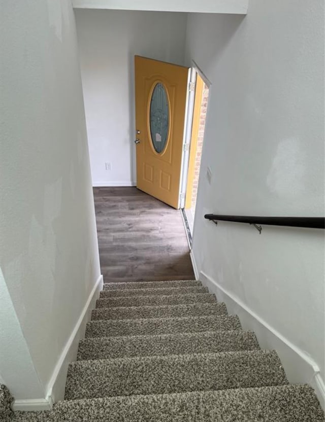 staircase featuring wood-type flooring