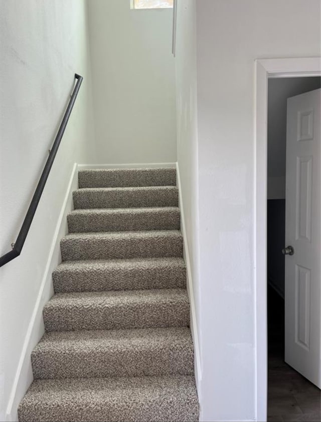 stairs with hardwood / wood-style flooring