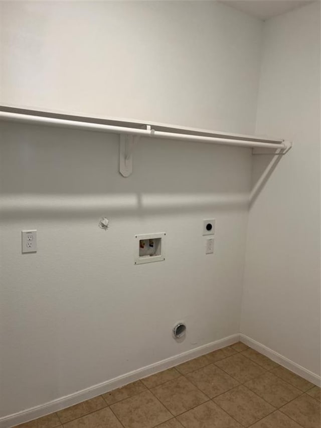 clothes washing area featuring electric dryer hookup, tile patterned floors, hookup for a washing machine, and gas dryer hookup